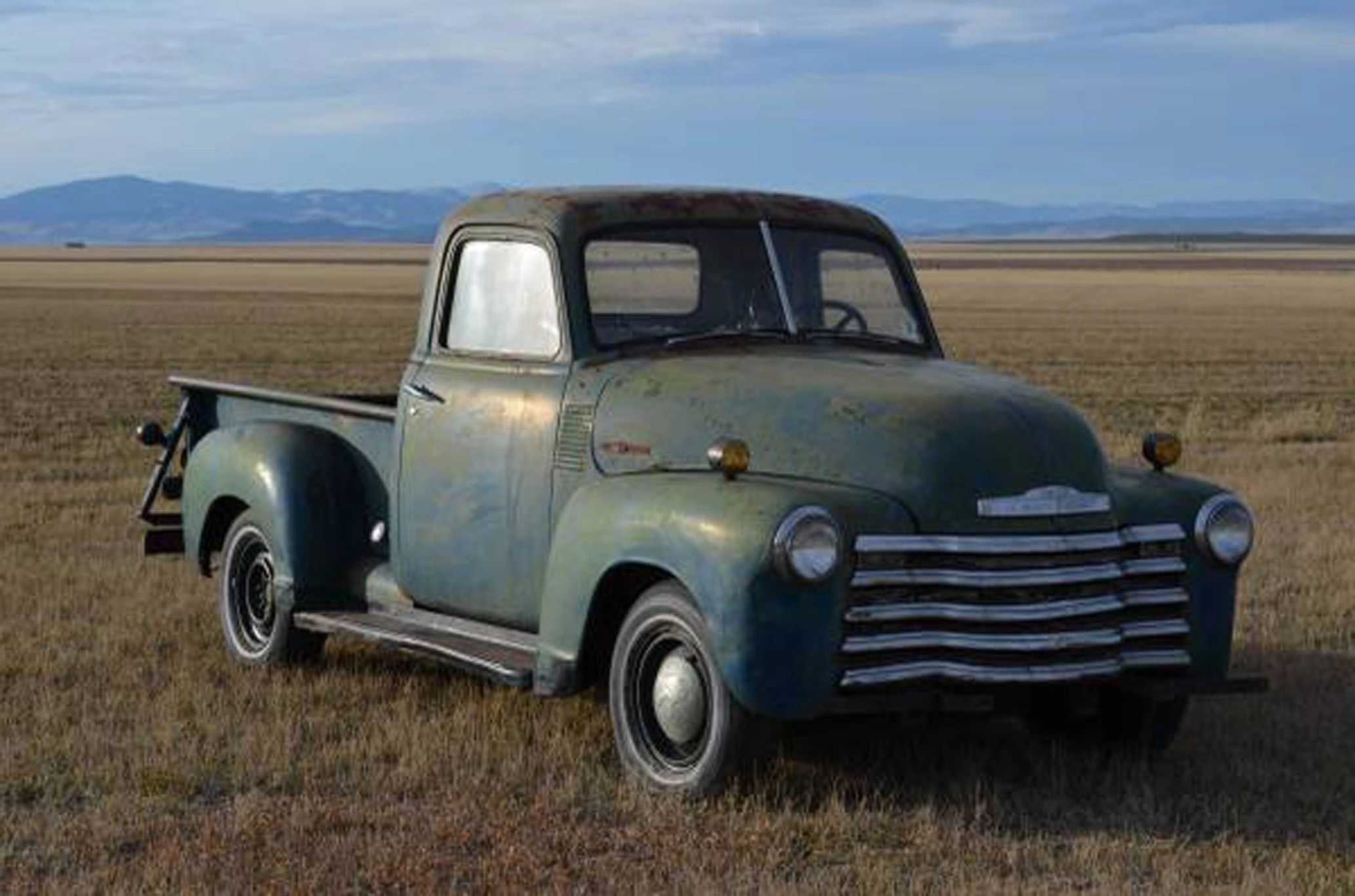 Vintage pickup truck in desert landscape