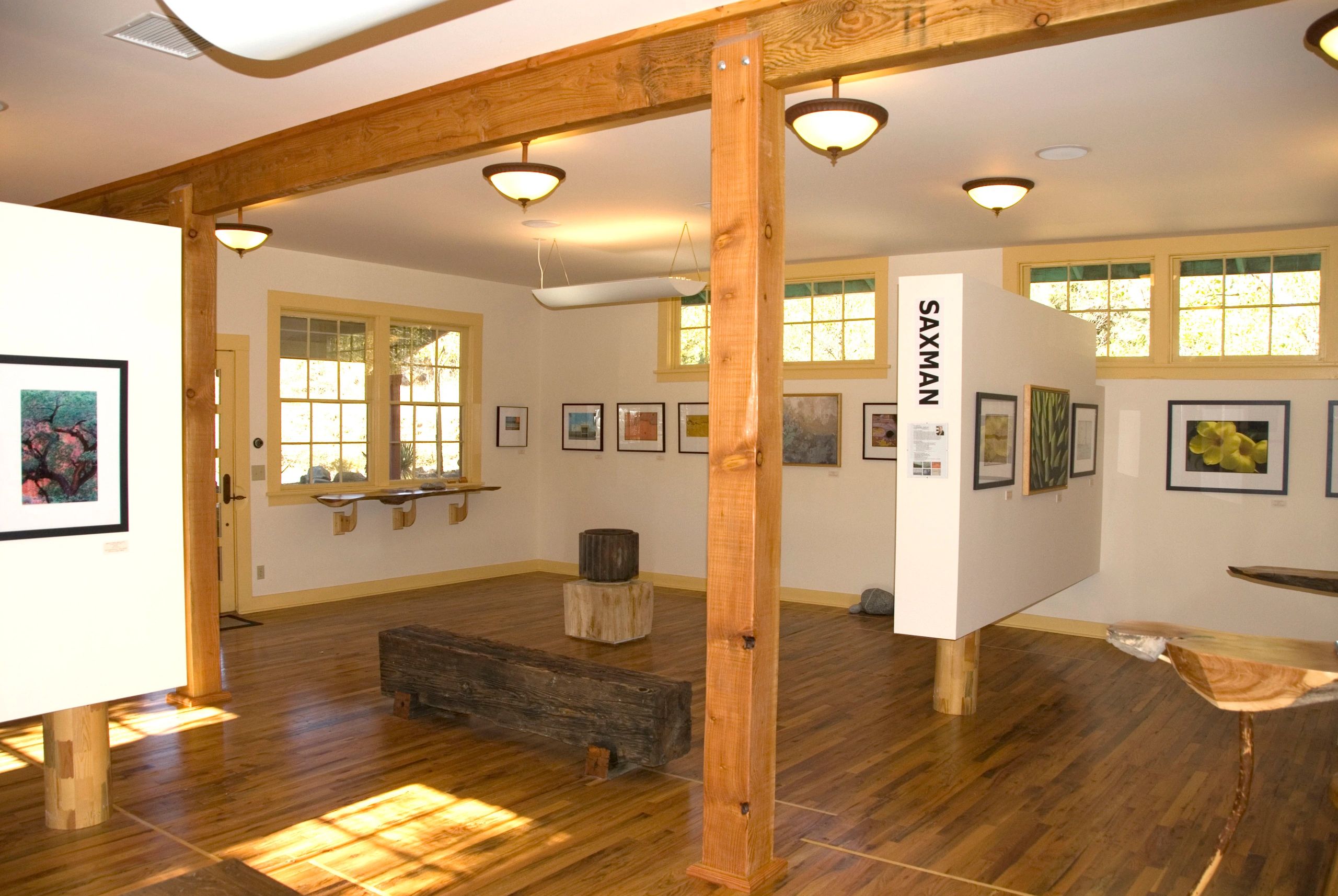 Fierro Canyon Gallery interior — wooden beam architecture with framed artwork